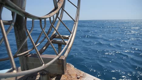 view off the bow of a fishing boat with a fishing winch in the foreground