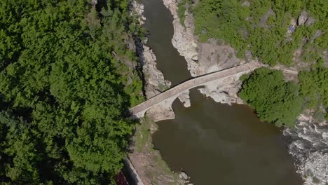 far aerial view of devil's birdge - an old roman bridge built in the 16th century associated with many legends and myths near ardino in rhodope mountains bulgaria