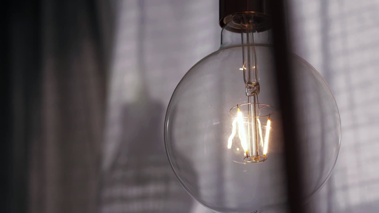 Light bulb showing glowing tungsten filament. Close up