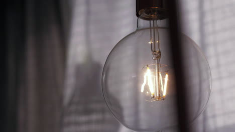 light bulb showing glowing tungsten filament. close up