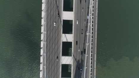 aerial shot of vehicles moving on san francisco–oakland bay bridge with city in background