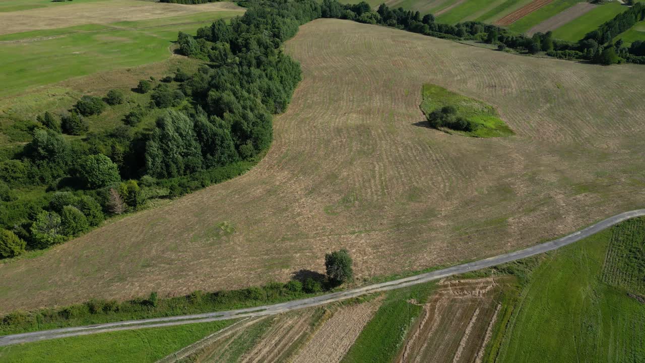 Stunning slow motion tilt up over agricultural hills in Europe on summer day