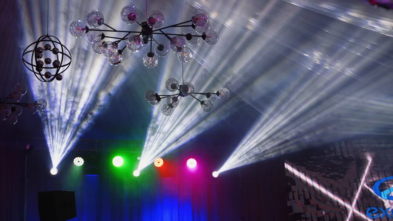 Bright lasers sparkling in the disco club. Led lighting equipment. Colorful spotlights shimmering in the nightclub.