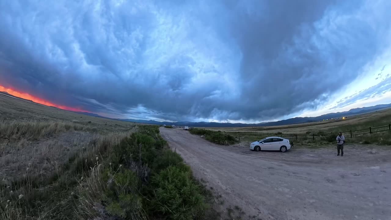 Ultra-wide photographer in a Utah Red Horizon Storm Sunset Time Lapse