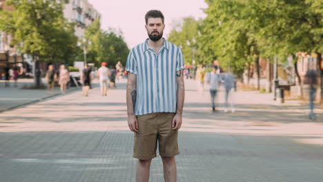 man in a striped shirt on a city street