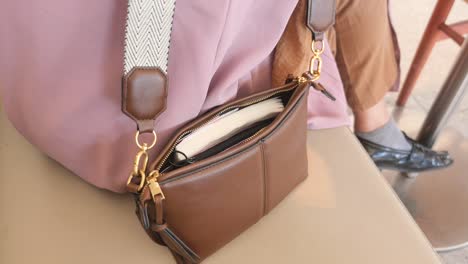 woman reaching for her phone in her purse