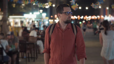 man walking through a night market