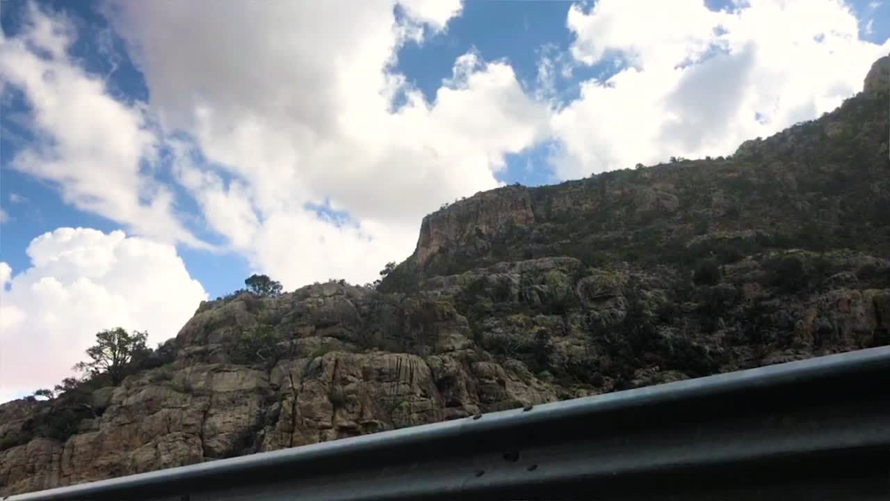 Panning timelapse of clouds rolling over mountains.