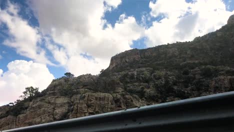 panning timelapse of clouds rolling over mountains.