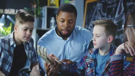 students and teacher working on a craft project