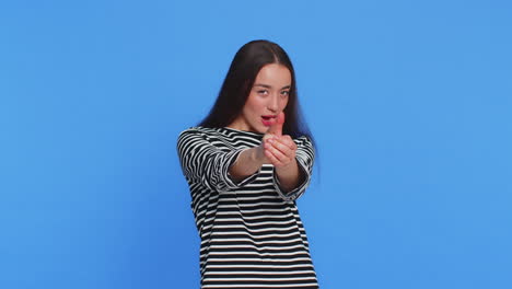 young woman pointing around with finger gun gesture making choice shooting killing with hand pistol
