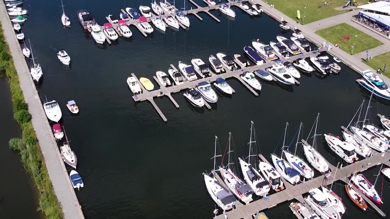 Docked yachts and sailboats in local pier, aerial drone view