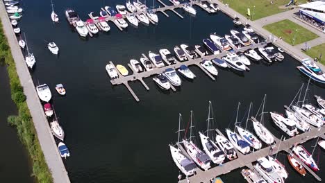 docked yachts and sailboats in local pier, aerial drone view