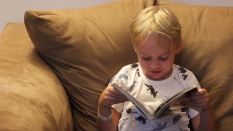 little boy reading comic book laughing