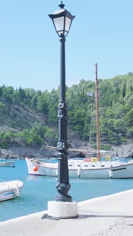 picturesque harbor scene with sailboat and streetlamp