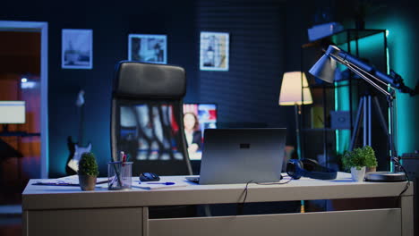 home office desk in front of smart tv displaying news program broadcasting