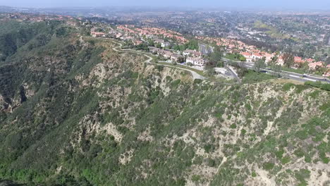 slow motion aerial drone flyover of luxury homes over laguna niguel, orange county, california facing aliso creek