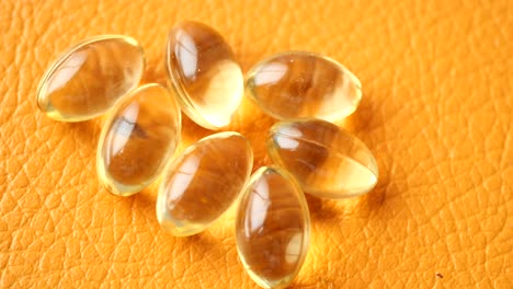 close-up of yellow capsules on orange background