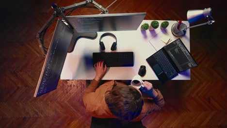 Time-lapse-of-software-technician-writing-code-on-computer-and-laptop-at-home