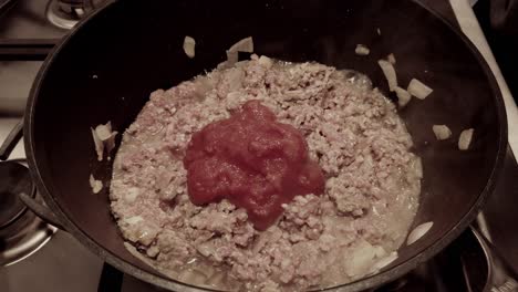 cooking ground beef with tomatoes and onions
