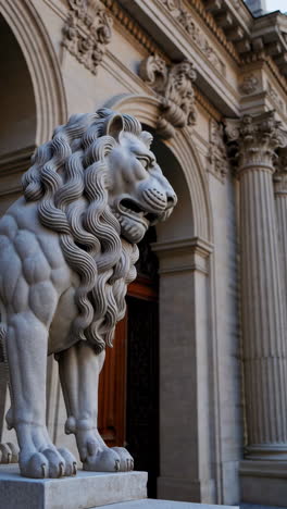 stone lion statue in front of a building