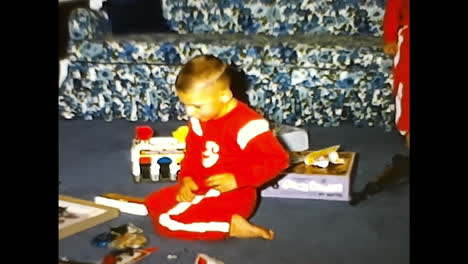 kids sitting on top of bed. circa usa - 1970s: two children sitting side by side on a bed in a 1970s video archive from the usa.