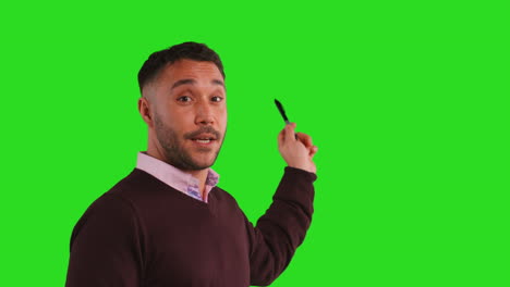 Close-Up-Studio-Portrait-Of-Mature-Male-Teacher-Talking-To-Class-Standing-Against-Green-Screen-Background-3