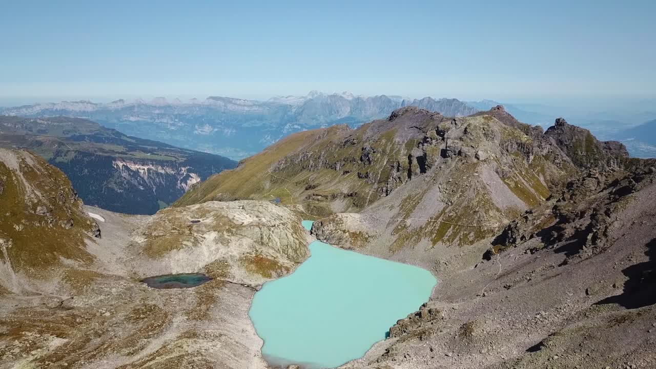 Drone shot of the green Wildsee in Pizol, in the Glarus Alps, St. Gallen, Switzerland