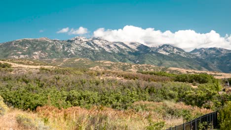 a billowing cloudscape over the rocky mountains as seen from highland, utah - panoramic motion time lapse