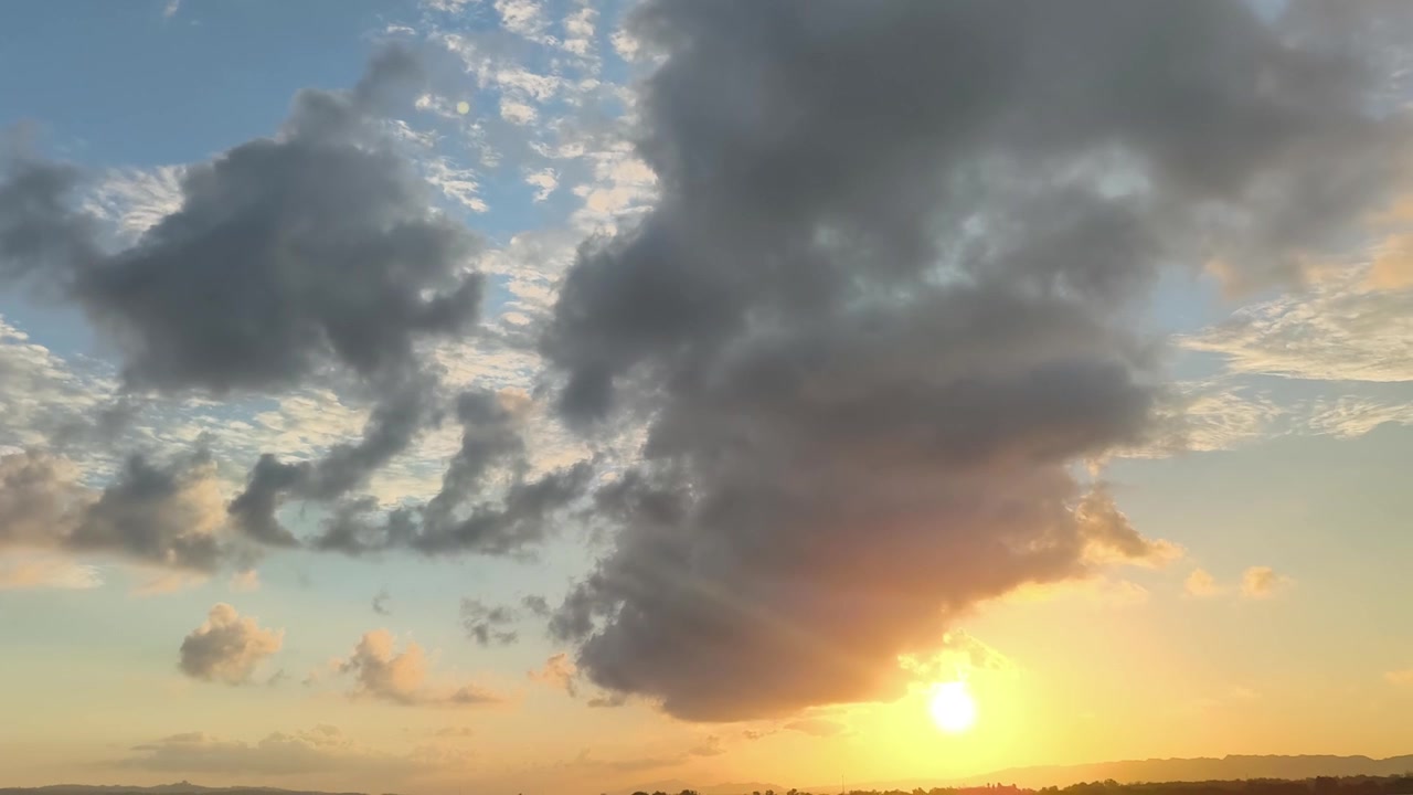 Golden Sunset Over Horizon With Dramatic Clouds