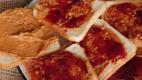 plate full of peanut butter and jelly sandwiches rotating, turning round