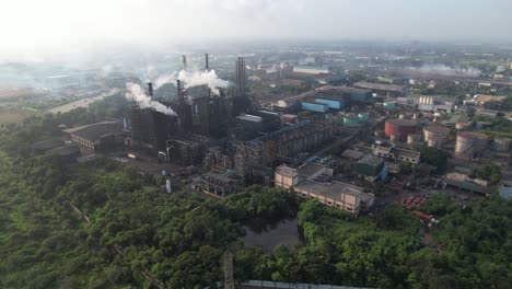 aerial view of a large industrial factory with smoke pollution