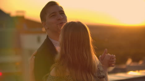 Girl-with-a-man-spinning-in-a-dance-on-the-roof-and-kissing.