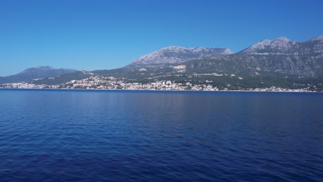 Flying-Above-Blue-Adriatic-Sea-Water-in-Kotor-Bay-With-Herceg-Novi-Town-in-Background,-Montenegro,-Drone-Shot