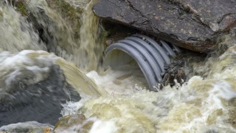 Floodwater from heavy rain in Norway rushes into drainage pipe
