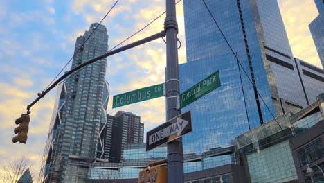 wide shot of the columbus circle and central park west street signs