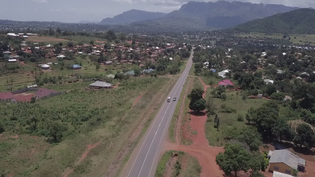 공중은 안개 낀 고원 마을, 동아프리카에 가까운 고속도로에서 버스를 따라갑니다.
