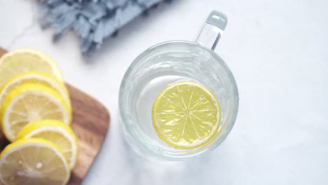 refreshing glass of lemon water with lemon slices