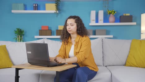 Young-woman-looking-at-laptop-is-unmotivated-and-bored.