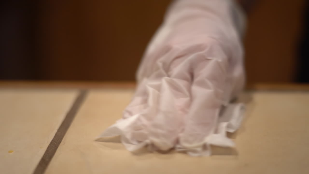 Covid-19 Protection and Disinfection. Close Up of Hand in Glove Cleaning Surface With Sanitiser, Slowmotion