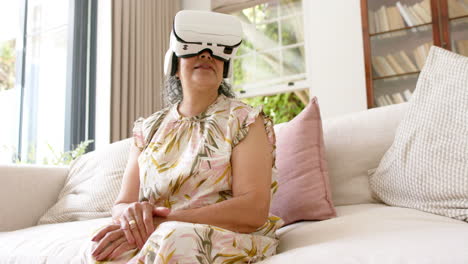 senior biracial woman explores virtual reality at home