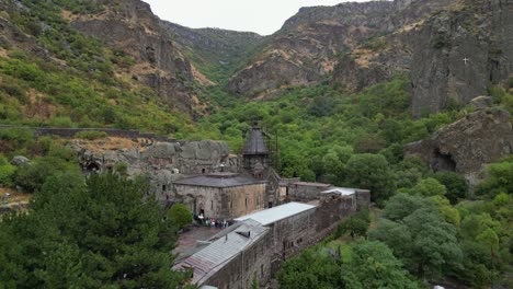 Aerial-rises-over-Geghard-Monastery-in-rugged-Armenian-rock-gorge