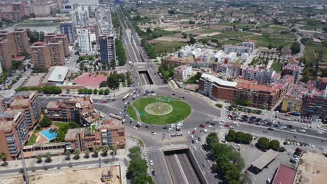 aerial reveal of a traffic circle in a coastal port city