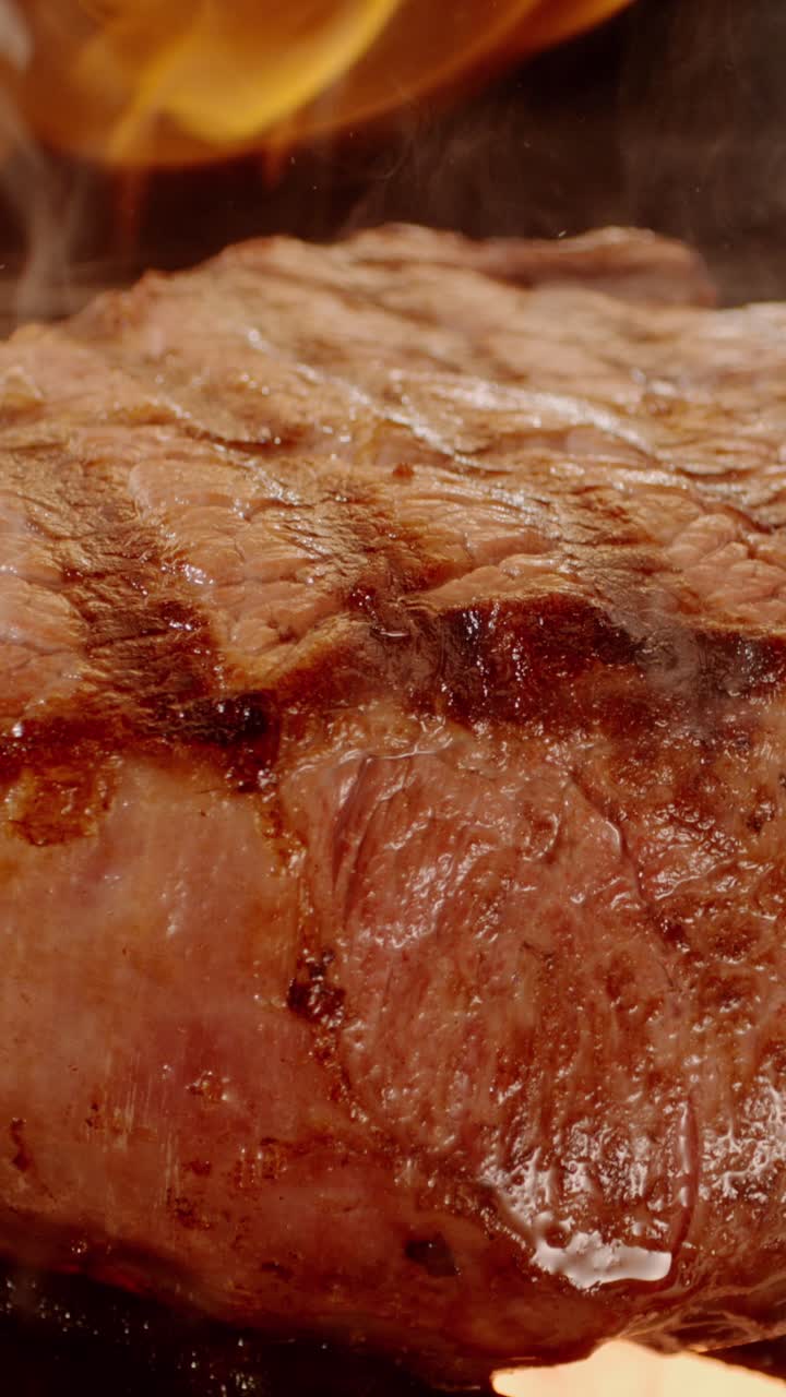 Close-up of a juicy steak being grilled