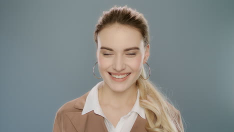 business woman smiling on grey background. close up of young woman