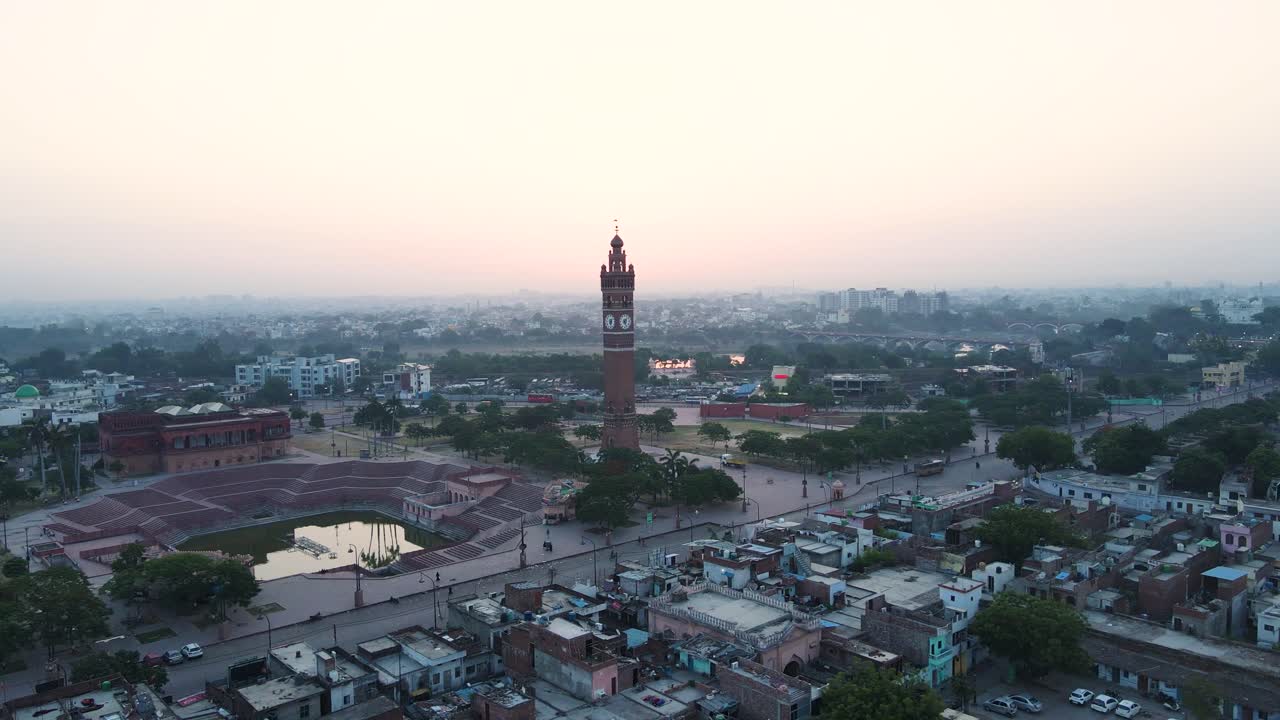 Breathtaking aerial capture of Lucknow's Clock Tower at dawn, with the surrounding buildings lit by the soft glow.
