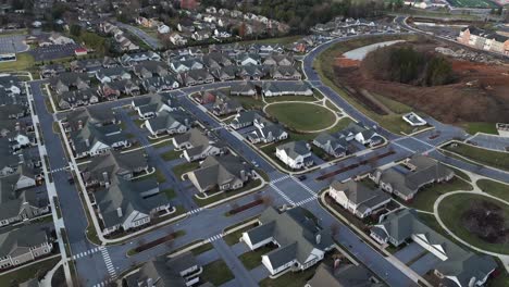 Similar noble residential area in rural suburbia of american town. Sunset time in Pennsylvania. Aerial rising top down shot. Grey villas and single family houses with white facade.