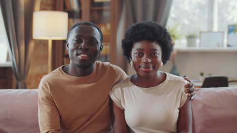 portrait of happy african american couple on sofa