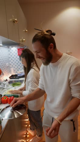 couple cooking together in kitchen