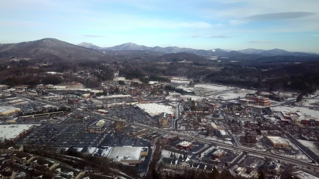 Aerial push into Boone North Carolina with Snake Mountain and Howard's Knob in Background